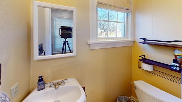 half bath with a sink and toilet