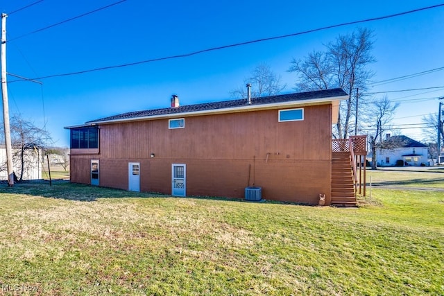 back of property with a lawn and a chimney