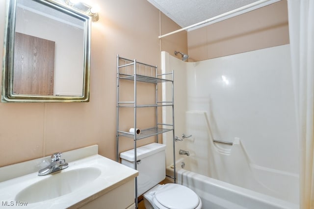 full bath with bathtub / shower combination, toilet, vanity, and a textured ceiling