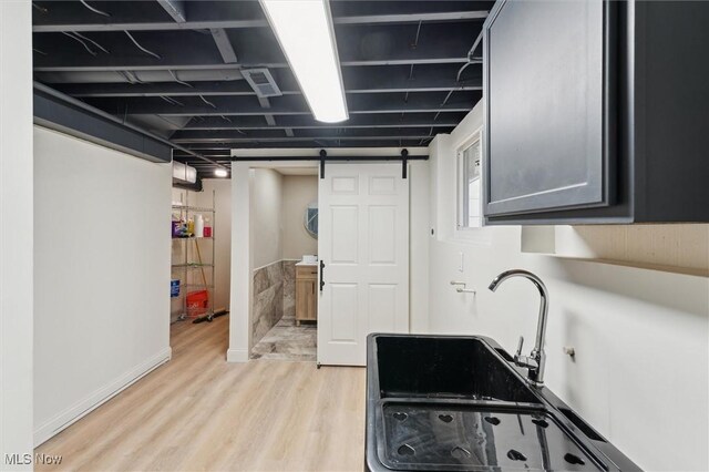 kitchen with light wood-style flooring and a barn door