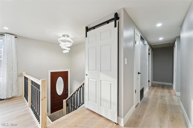 entryway with recessed lighting, light wood-style flooring, and baseboards