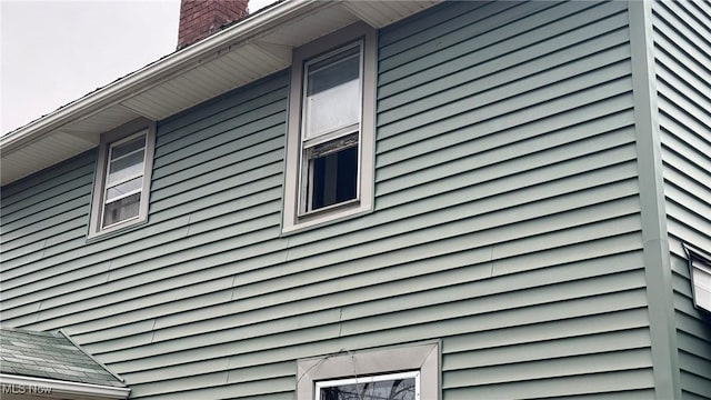 view of property exterior featuring a chimney