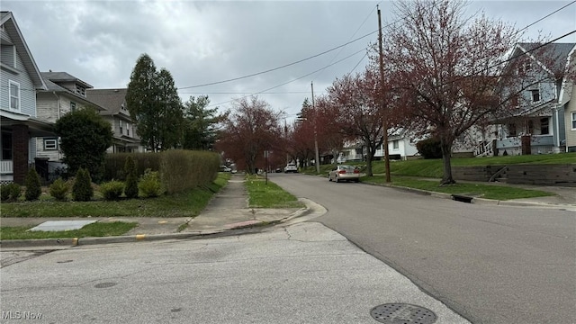 view of road with curbs, sidewalks, and a residential view