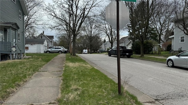 view of street with a residential view, curbs, and sidewalks