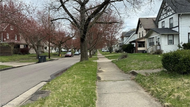 view of street featuring curbs, sidewalks, and a residential view