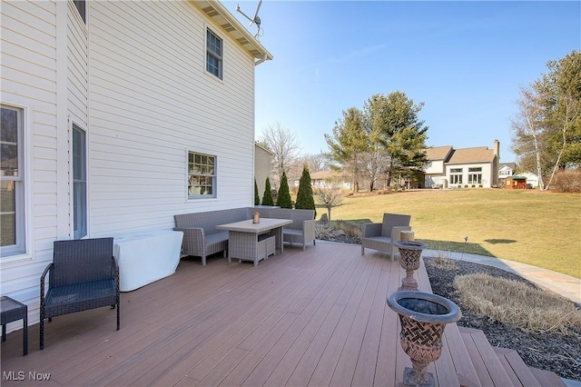 wooden terrace with a lawn