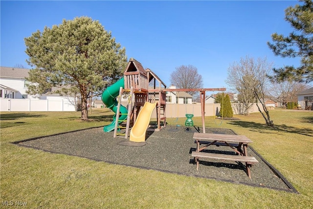 community jungle gym with a lawn and fence