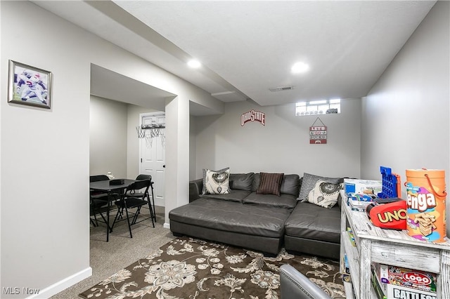 living area featuring visible vents and carpet