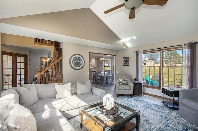 living room with stairway, baseboards, high vaulted ceiling, ceiling fan, and french doors