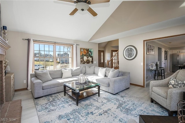 living room featuring a ceiling fan, light wood-style floors, baseboards, and high vaulted ceiling