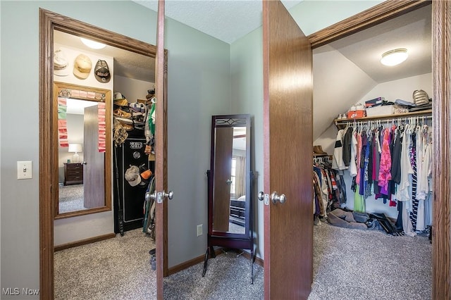 spacious closet with lofted ceiling and carpet floors