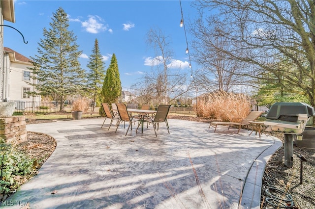 view of patio featuring outdoor dining space and fence