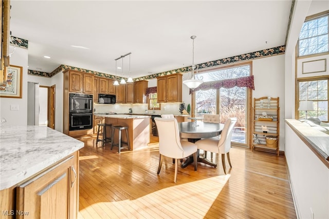 dining area with light wood-style floors