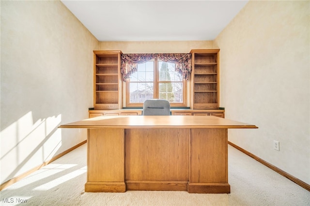 unfurnished office with light colored carpet and baseboards