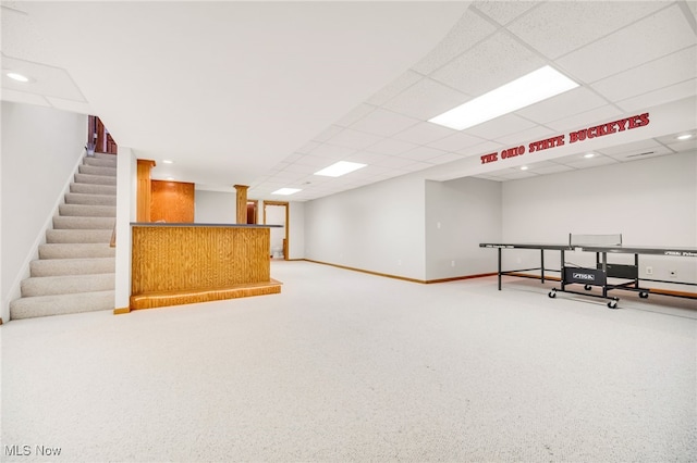 interior space featuring carpet, baseboards, a drop ceiling, recessed lighting, and a bar