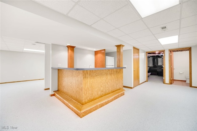 bar featuring indoor wet bar, a paneled ceiling, light colored carpet, and freestanding refrigerator