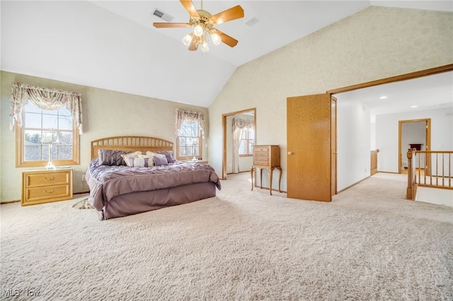 bedroom featuring visible vents, multiple windows, high vaulted ceiling, and light carpet