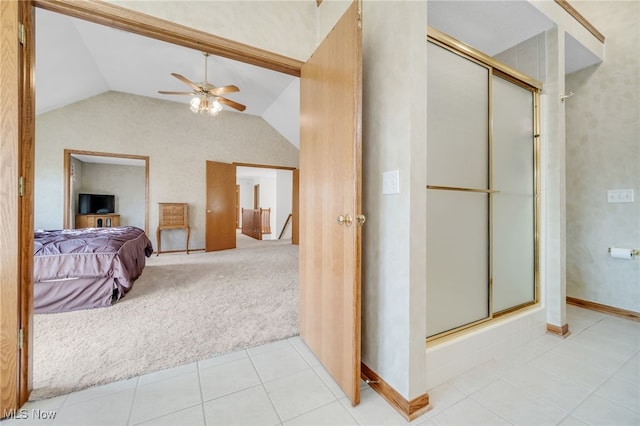 bathroom featuring tile patterned flooring, ceiling fan, lofted ceiling, a shower with shower door, and ensuite bath