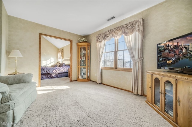 carpeted living area with baseboards and visible vents