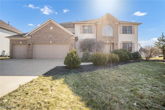 view of front of home with a front lawn, brick siding, a garage, and driveway