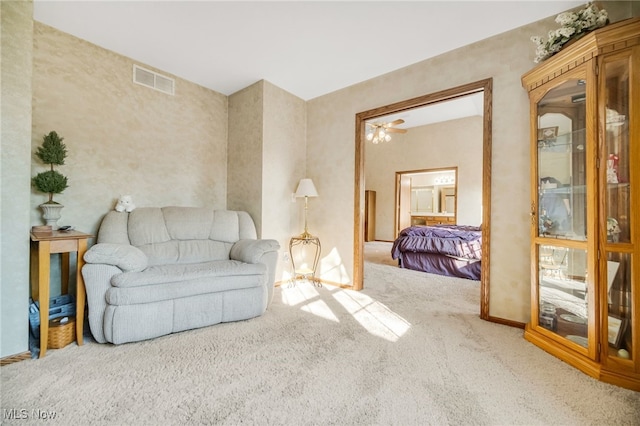 living area featuring visible vents, carpet floors, and baseboards