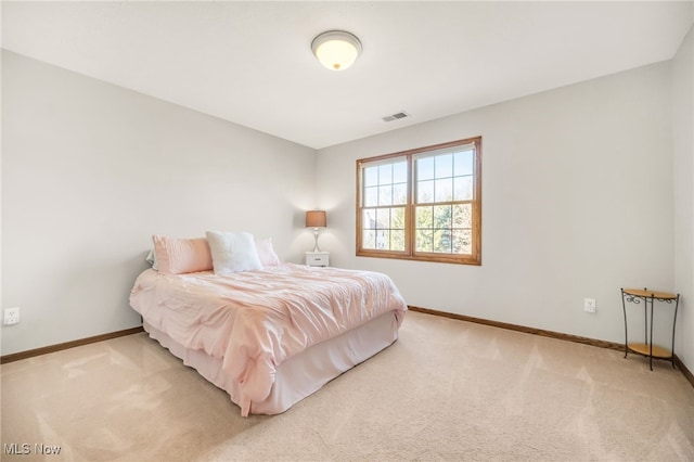 carpeted bedroom with visible vents and baseboards