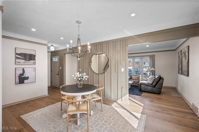 dining room featuring recessed lighting, baseboards, light wood-style floors, and ornamental molding