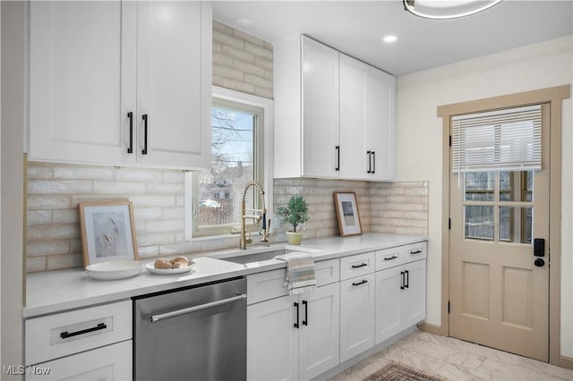 kitchen with marble finish floor, a sink, white cabinets, light countertops, and dishwasher