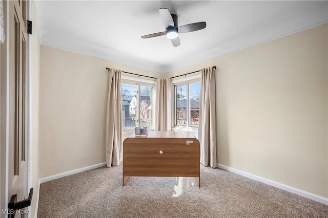 unfurnished room with a ceiling fan, baseboards, and carpet floors