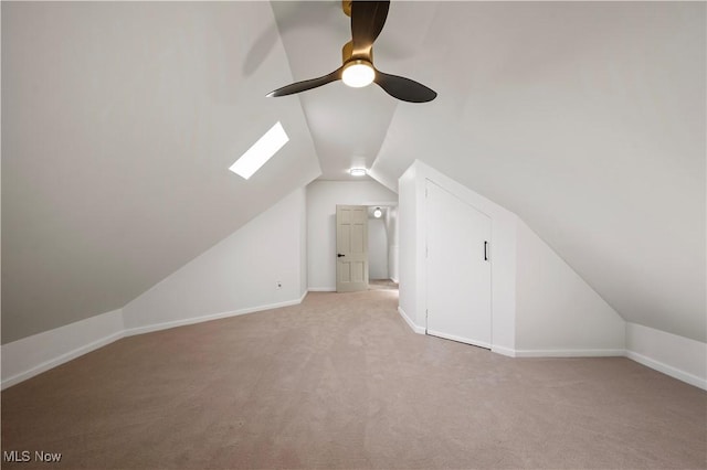 bonus room with lofted ceiling, baseboards, and light carpet