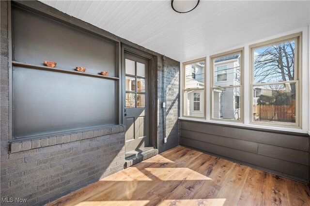 unfurnished sunroom featuring a wealth of natural light