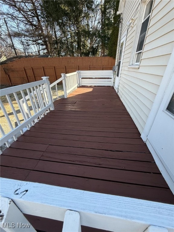 wooden terrace featuring fence