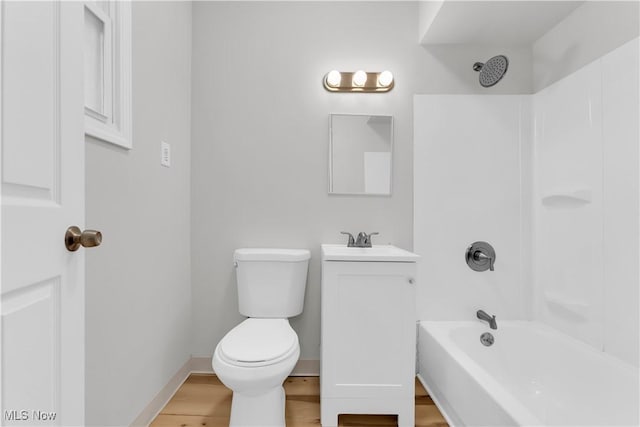 full bathroom with toilet, shower / bathtub combination, wood finished floors, baseboards, and vanity