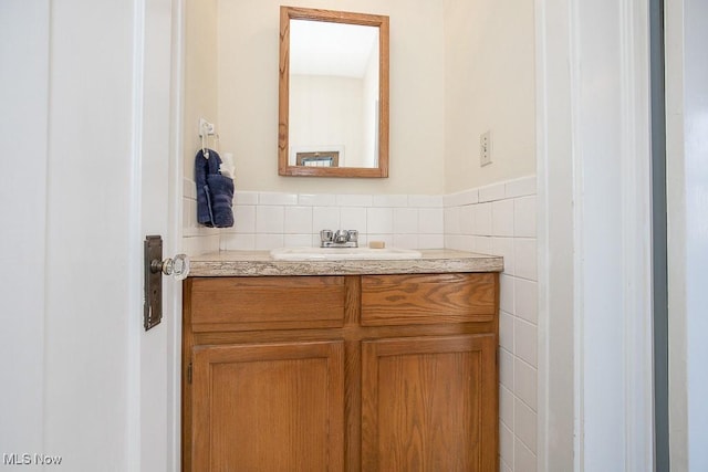 bathroom with vanity, tile walls, and wainscoting