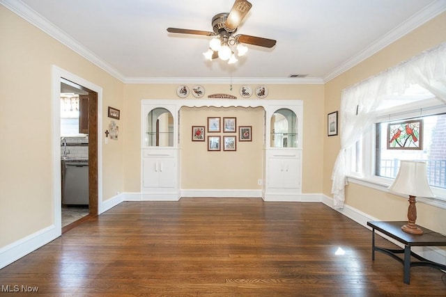 entrance foyer featuring dark wood-type flooring, baseboards, visible vents, and ornamental molding