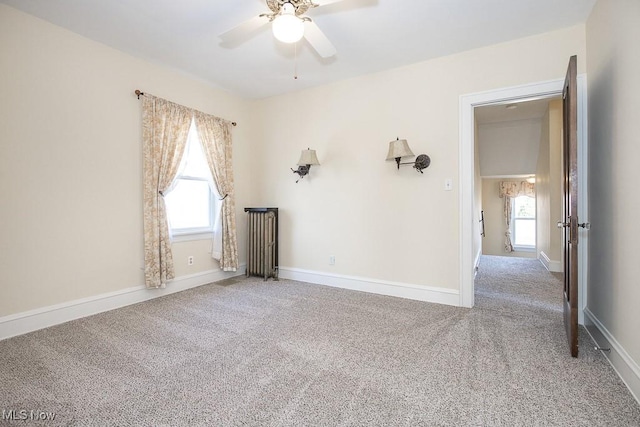 unfurnished room featuring carpet flooring, plenty of natural light, and baseboards