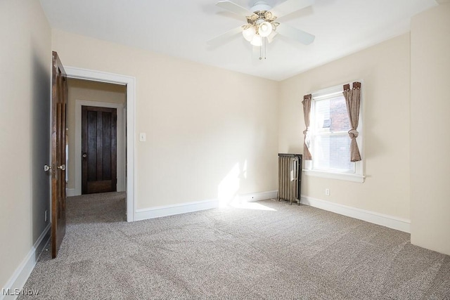 carpeted empty room featuring baseboards and ceiling fan