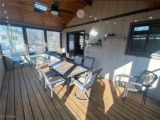 deck featuring outdoor dining area and a ceiling fan