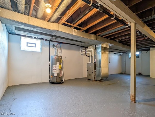 basement featuring heating unit and water heater