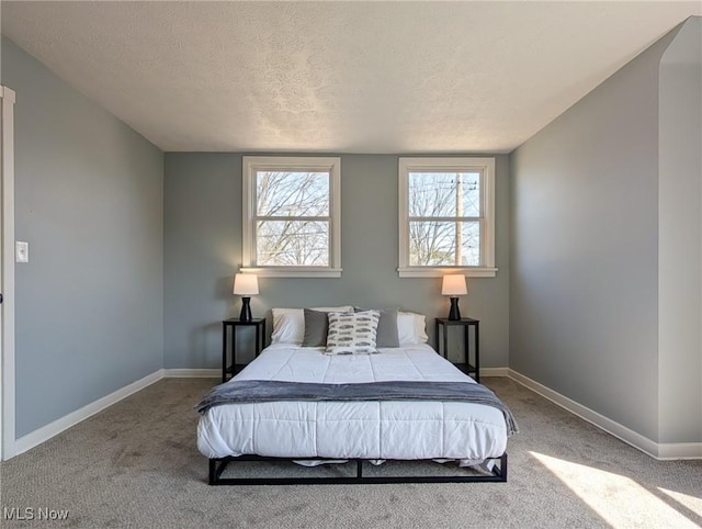 bedroom featuring carpet and baseboards