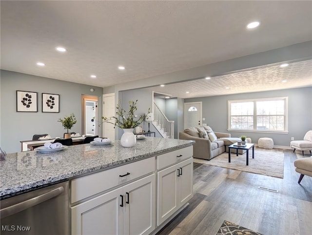 kitchen featuring open floor plan, dishwasher, recessed lighting, dark wood-style floors, and white cabinetry