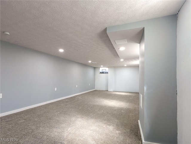 unfurnished room with recessed lighting, baseboards, carpet floors, and a textured ceiling