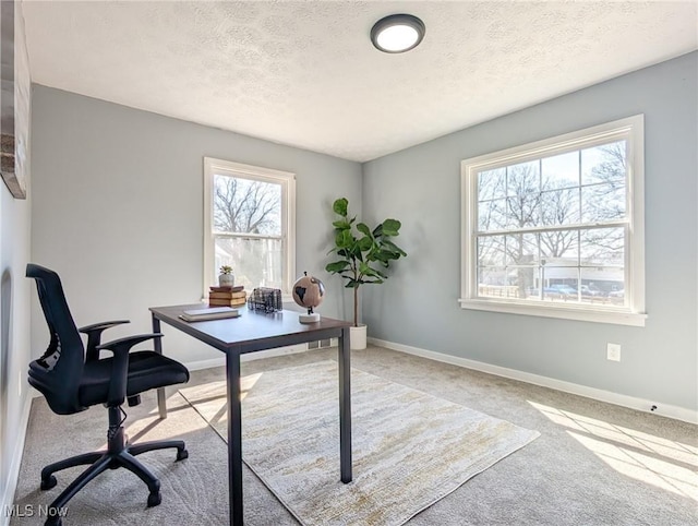 office with carpet flooring, a textured ceiling, and baseboards