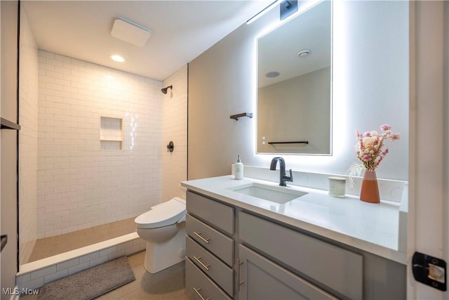 full bathroom with vanity, recessed lighting, a tile shower, tile patterned floors, and toilet