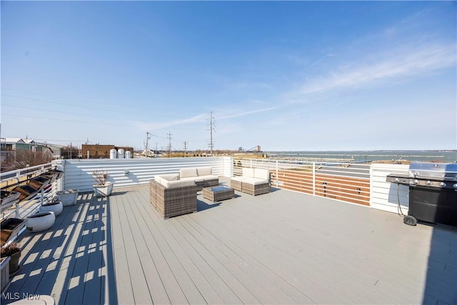 wooden deck with grilling area and an outdoor living space