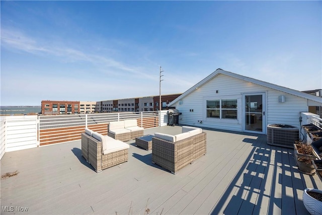 wooden terrace featuring grilling area, an outdoor living space, and cooling unit