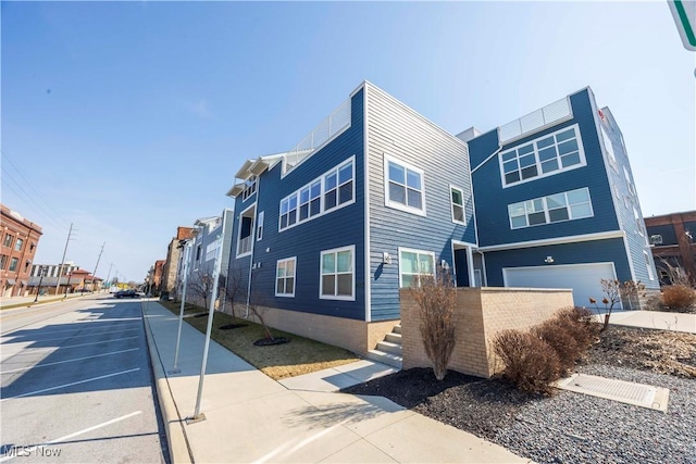 view of front of property with a residential view and driveway