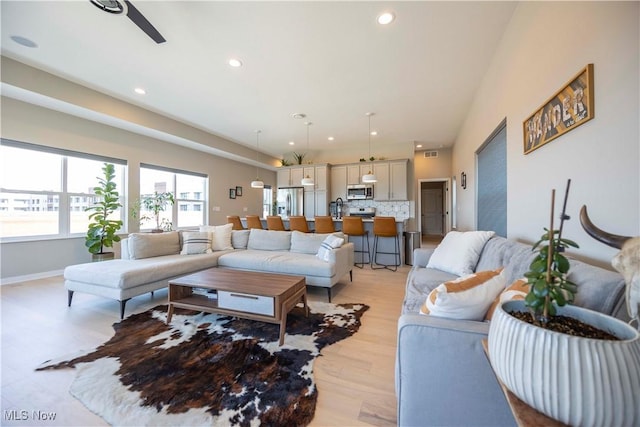 living room with light wood finished floors, visible vents, baseboards, recessed lighting, and a ceiling fan