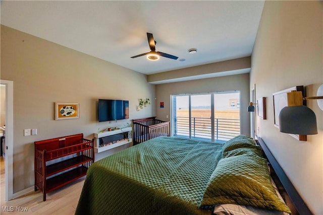 bedroom featuring access to exterior, baseboards, light wood finished floors, and ceiling fan