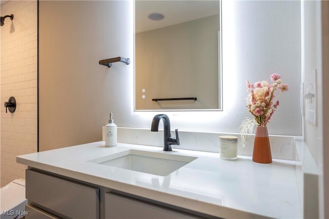 full bathroom with vanity and a tile shower